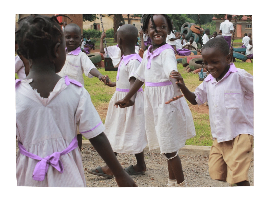Group of Uganda children wearing purple school uniforms playing together outside. 