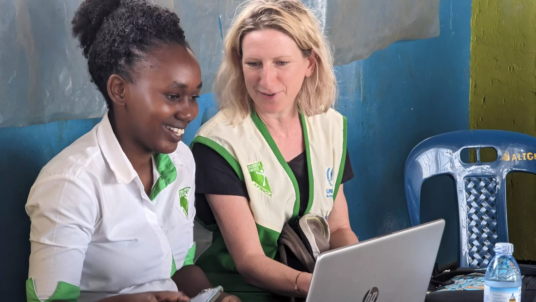 Gemma from COTEUK and Marble from COTE Africa sat together smiling looking at a laptop