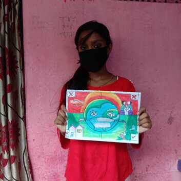 A child in India holding her entry for the drawing competition