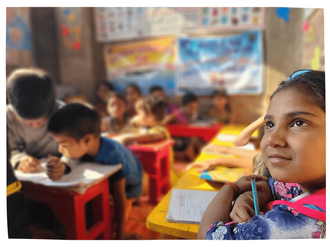 Rohingya girl watches intently at the screen in her classroom in Bangladesh
