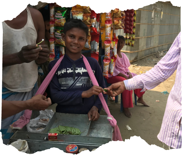 14 year old Bangladeshi boy with a mobile tray selling belel nuts in Cox's Bazar slum. 