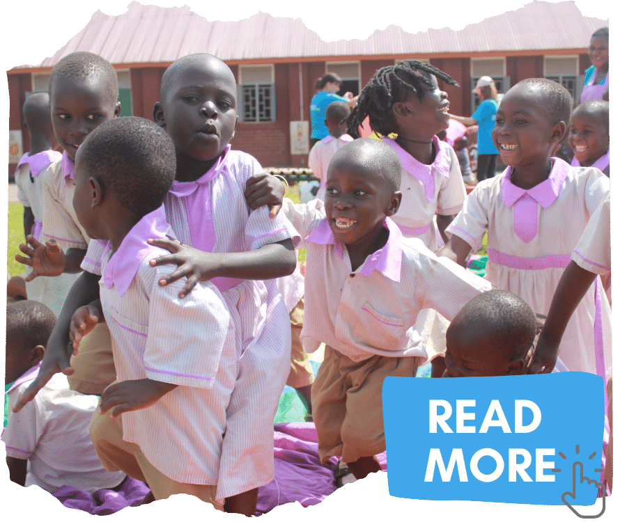 Group of Uganda children wearing purple school uniforms gathered together outside their school playing. You can click on the image to read more about the campaign to end child sacrifice in Uganda.