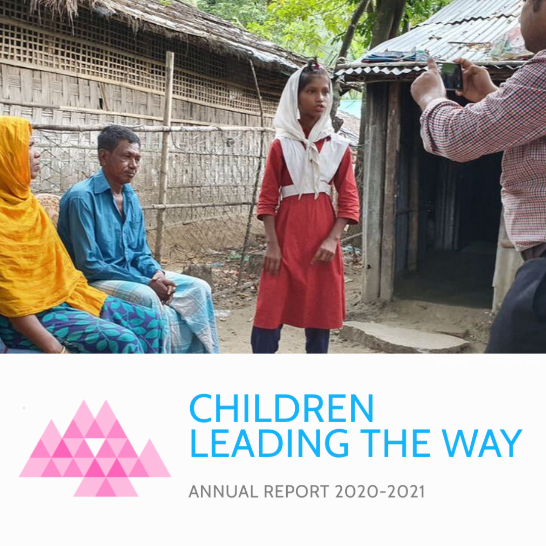 Title on image says 'Children are leading the way - Annual report 2020 - 2021' - this is below an image of a Bangladeshi girl being filmed talking outside her home as her parents sit beside her. 