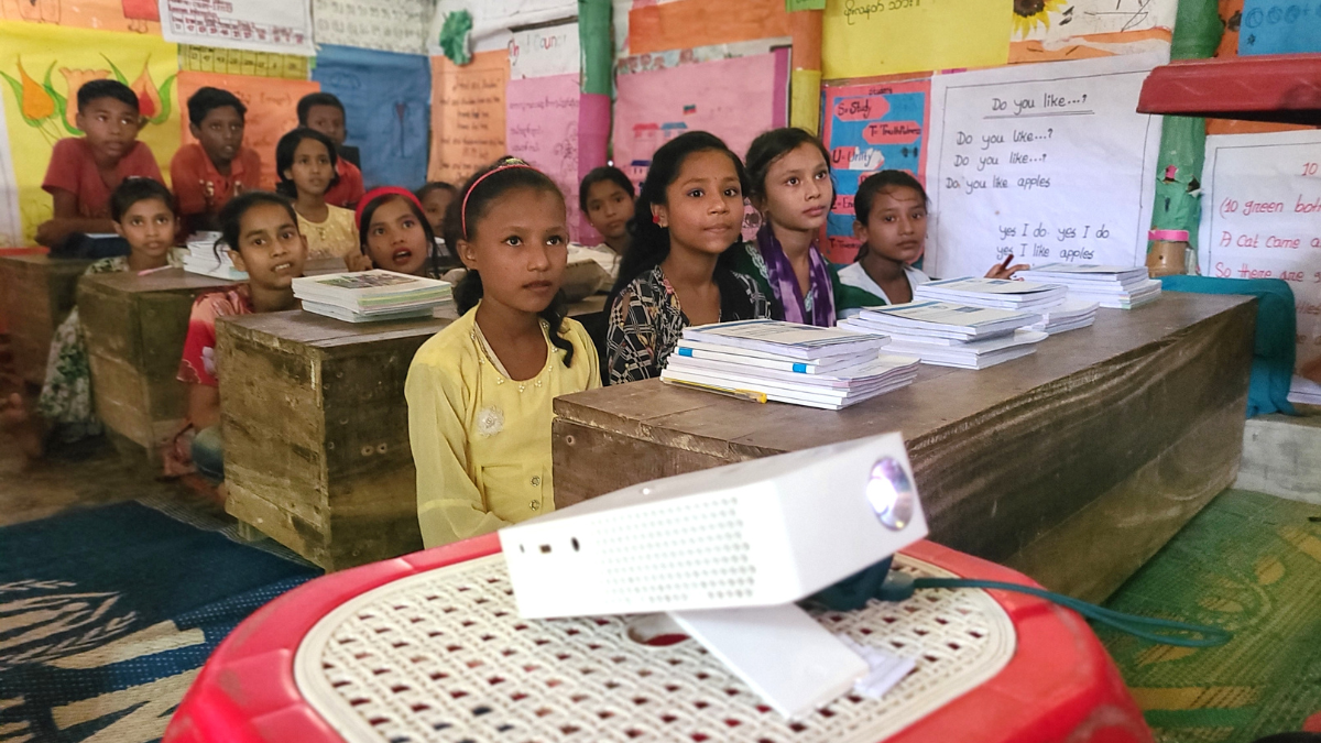 Children watching a digital lesson in a classroom in Bangladesh