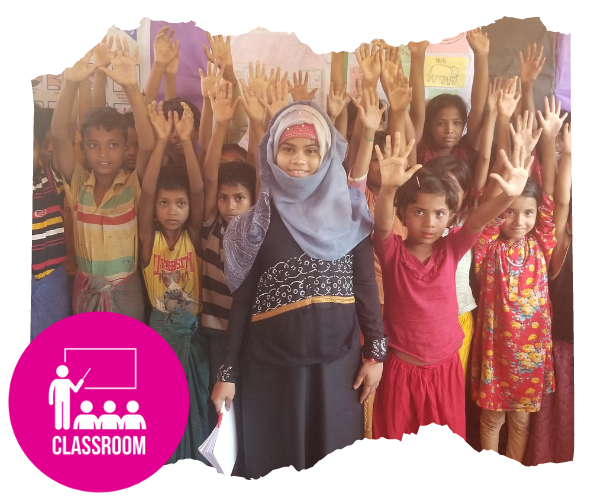 Rohingya teacher smiling directly at camera with her whole class of children behind her who are also looking at the camera and have their hands in the air. There is an icon attached to the image that represents 'classroom'. 