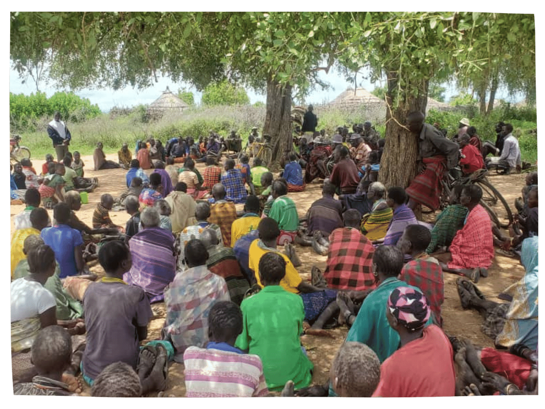 A large group gathering under trees in Uganda