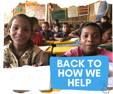 An Indian boy and girl sat at the front of a busy classroom. They are sat at bright yellow desks with books open in front of them on the desk. They are both looking at the camera and smiling. Behind them are other children busy at their desks. You can click on the image to go back to the page about how we help in India. 