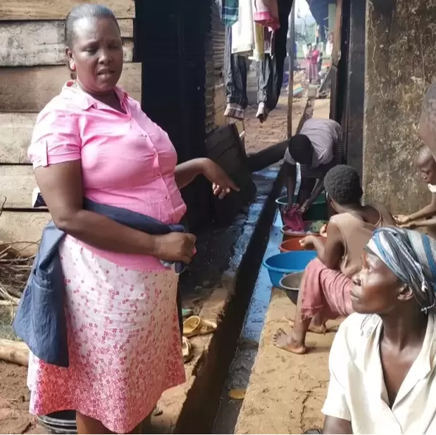 Babra in a slum community in Uganda talking to someone