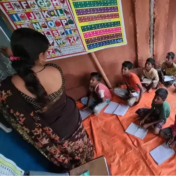 Children in Patna learning in a classroom with posters on the wall