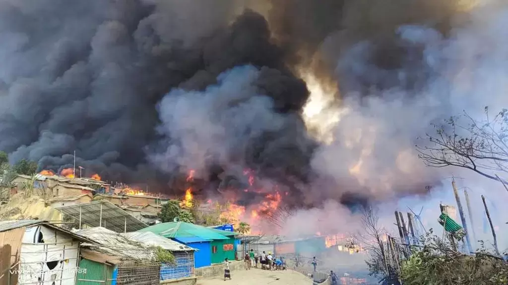 Black smoke fills the air above refugee homes in Kutupalong