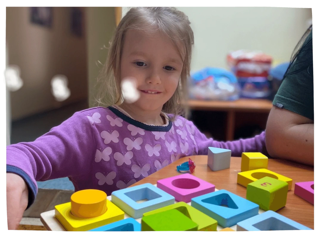 Girl playing with coloured blocks in Moldova