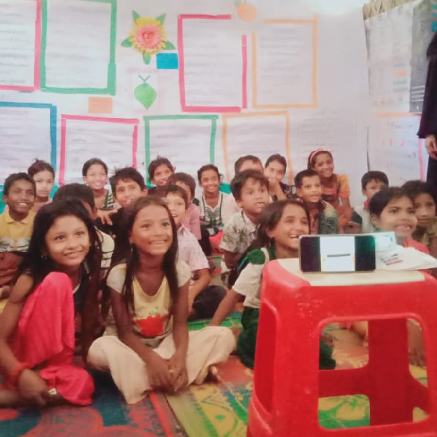 children smiling watching a digital lesson in the classroom