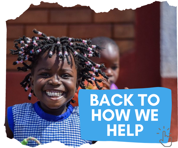 Image shows young Ugandan girl with braided hair with pink and blue beads in. She is grinning with all her teeth showing as she looks at the camera. She is wearing a blue and white checked top and holding a skipping rope. You can click on the image to return to the page detailing how we help in Uganda. 