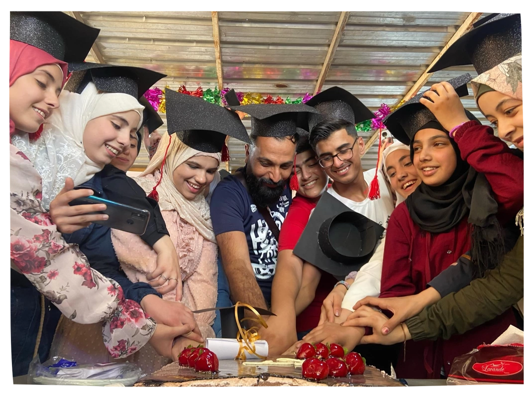 Group of grade 9 graduates celebrating with black caps on