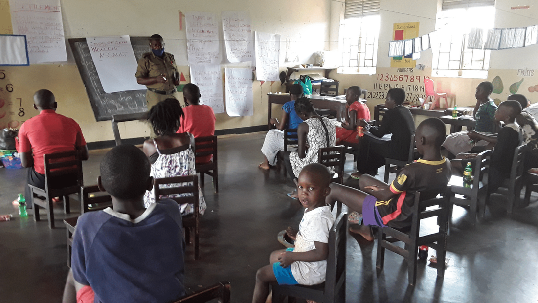 13 teenage members of the Child Rights Club in Loco sat in a classroom taking part in a workshop