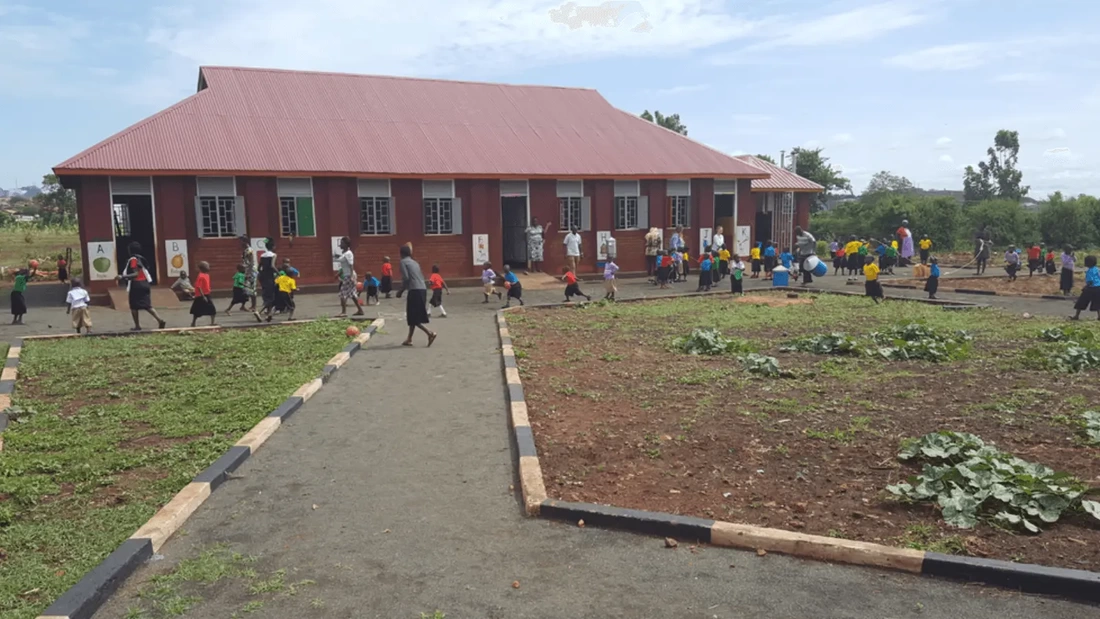 Loco preschool building with children playing outside
