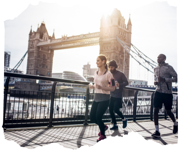 Runners on the Thames path by Tower Bridge in London