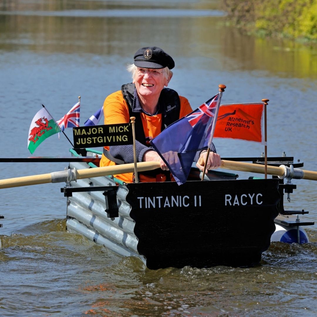 'Major Mick' rowing cheerfully in his homemade tin boat on the canal in Chichester