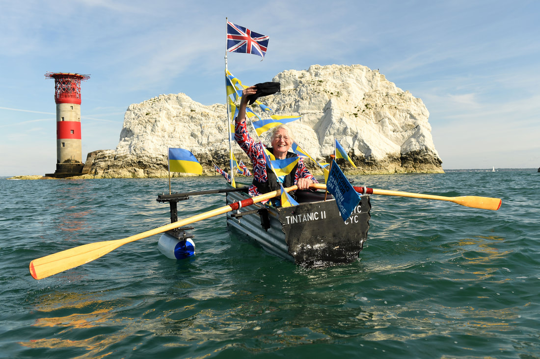 81 year old Mick Stanley is in his tiny tin boat donned with Union Jack and Ukrainian flags on the sea in front of the Needles on the Isle of Wight