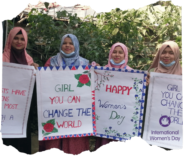 Staff in Bangladesh wearing headscarves holding up international women's day placards