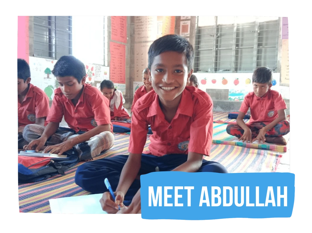 Abdullah smiling in his classroom