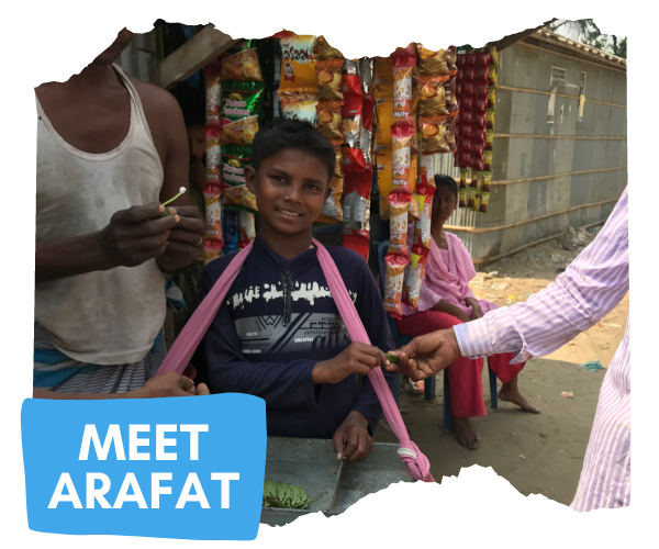 14 year old Arafat has a mobile tray of goods which is secured by some fabric around his neck. He is selling betel nuts and smiling at the camera. There is a button that says 'Meet Arafat'. 