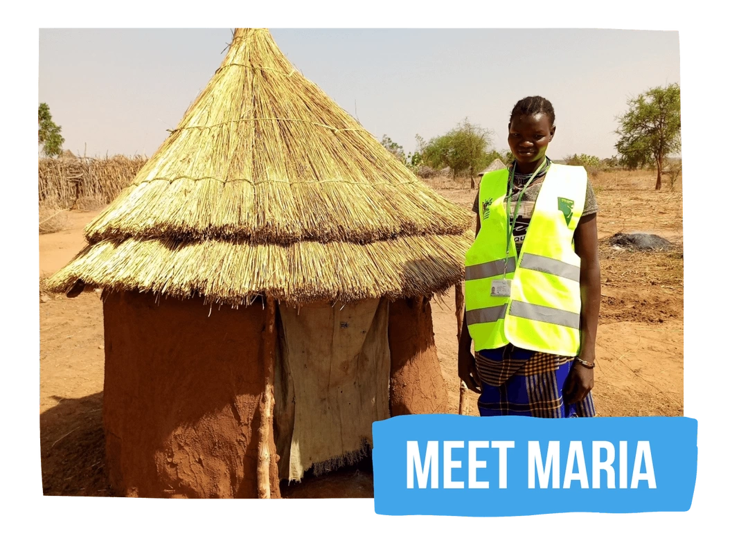 Maria stood by the latrine she built