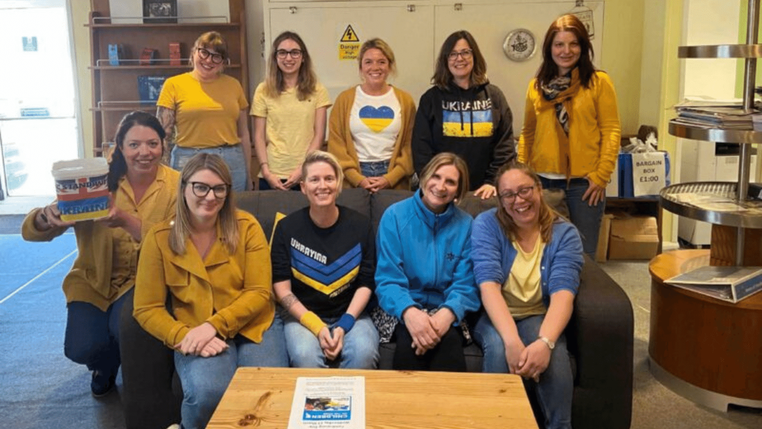 staf from Montezumas wearing blue and yellow fundraising in their office