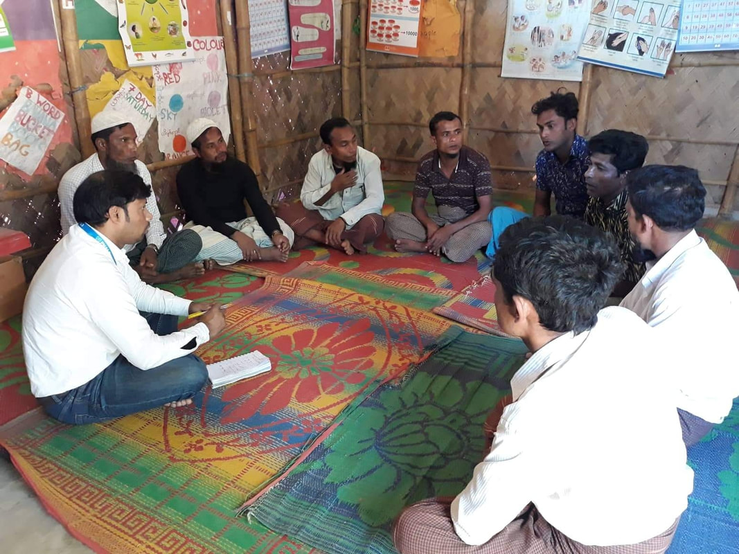 Project Officer Panesh running a parents group in the Kutupalong camp, Bangladesh