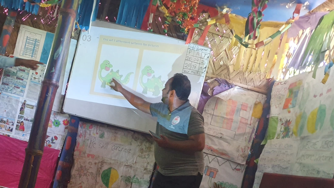 Teacher pointing toward the picture that is being shown on screen