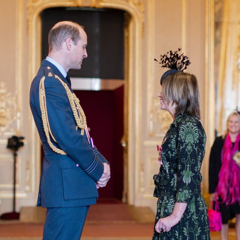 Rachel Bentley, CEO standing in front of Prince William inside a room at Windsor Castle