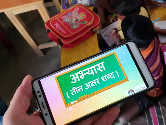 A small handheld phone used to demonstrate the technology used to deliver lessons in India