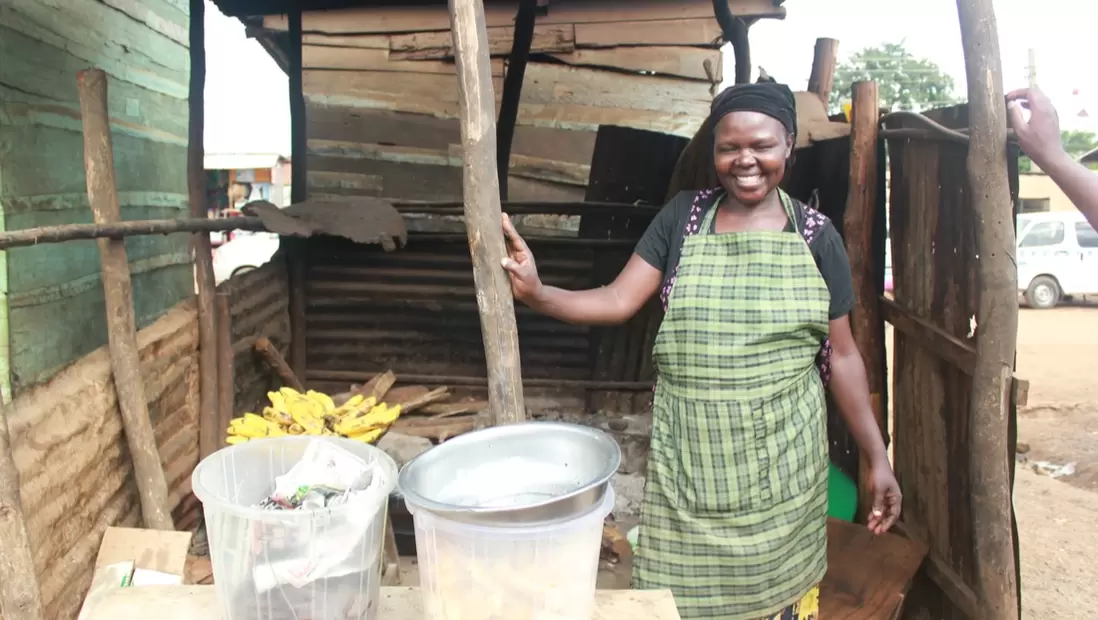 Margaret standing at a stall in Masese I