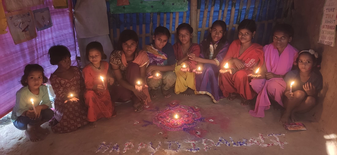 Line of female Indian learners with Diwali candles