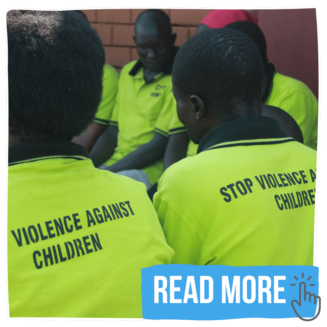 Child Protection Team members meeting wearing tshirts with 'stop violence against children' on the back