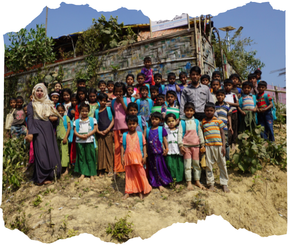 A group of Rohingya children standing in front of their camp classroom in Kutupalong refugee camp in Bangladesh