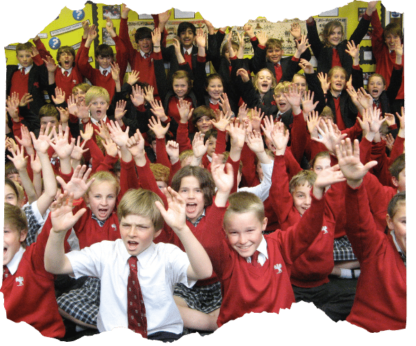 A large group of school children sat down in an assembly, they are cheering and waving