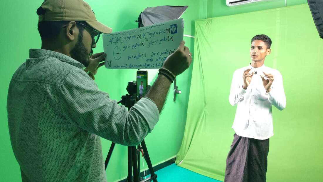 A teacher recording one of the digital lessons in a green screen studio