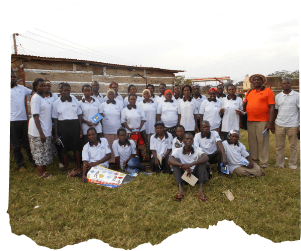 Members of the Child Protection Teams across six slum communities in Jinja, Uganda, gather together for a photo in their matching white tshirts / uniform. 