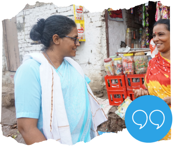 Sister Veena Jacob talks to a mother who has set up a shop as part of the programme. There is an icon with a quote mark showing that a quote from her is coming up. 